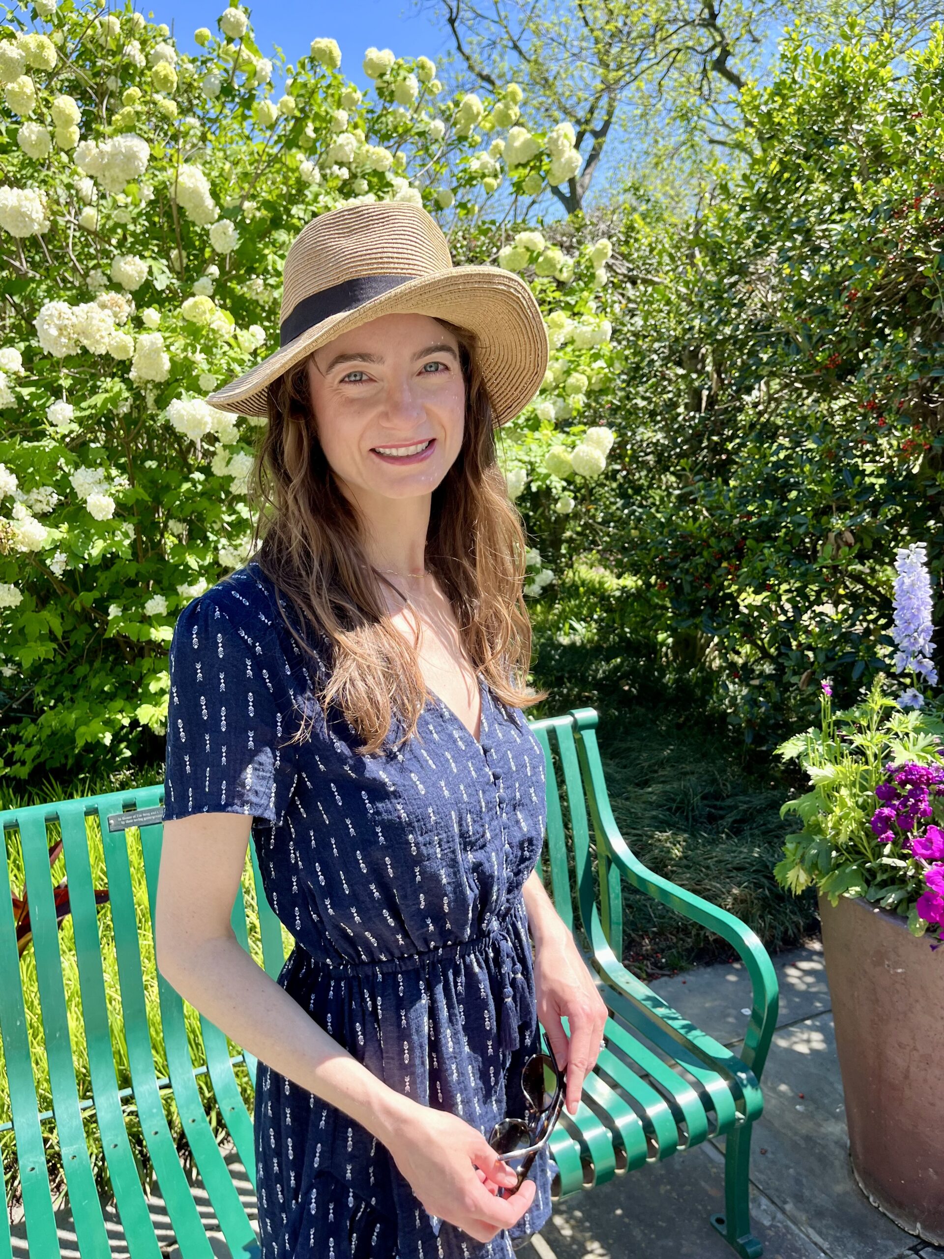 Jessica Russell Hilton at botanical garden wearing sunhat